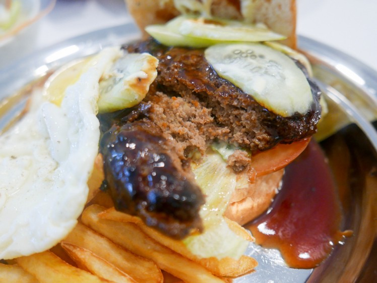 7. Hamburger sandwich with rich sauce, topped with fried egg