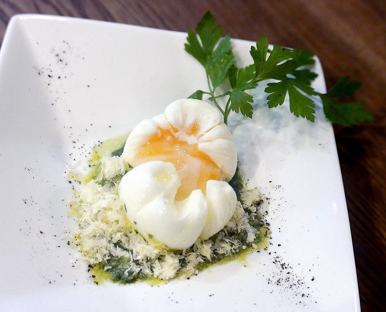 5. Poached egg with shaved cheese and pesto